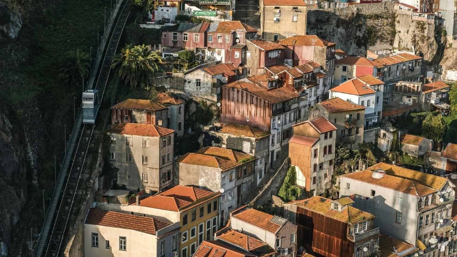 The Funicular dos Guindais ascends from Porto's upper level (Batalha) to the lower level (Ribeira), offering stunning views of the cityscape.