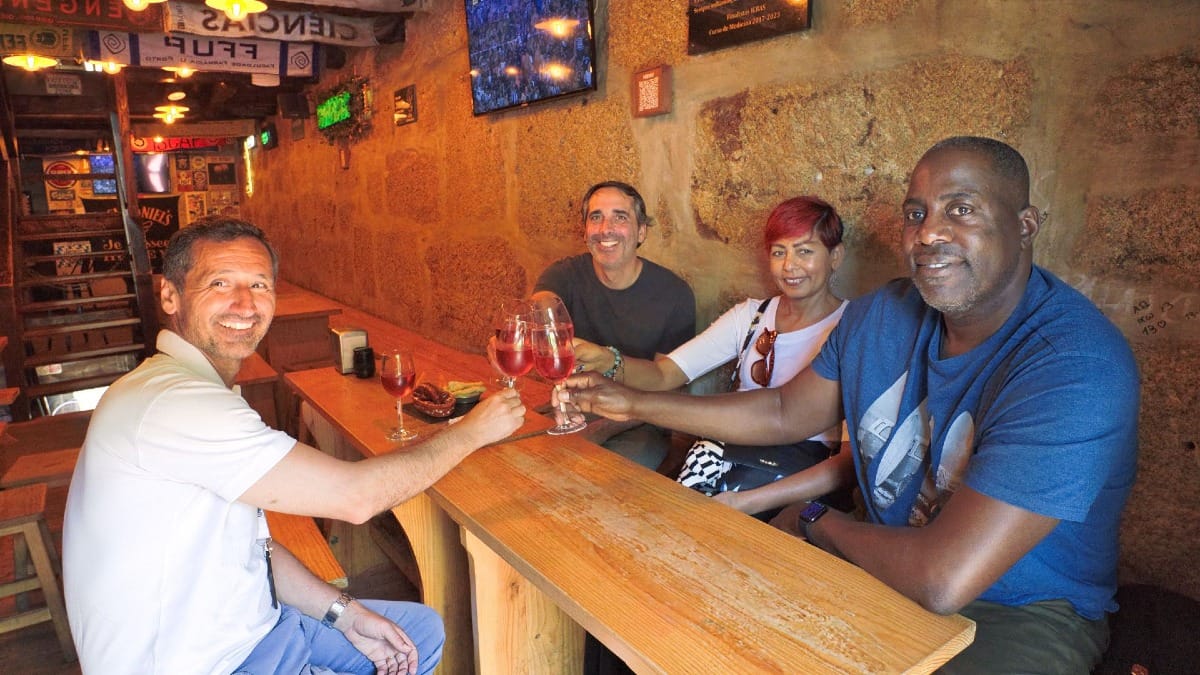 Group toasting with rosƩ wine at a local tavern in Porto during a Cooltour Oporto food tour