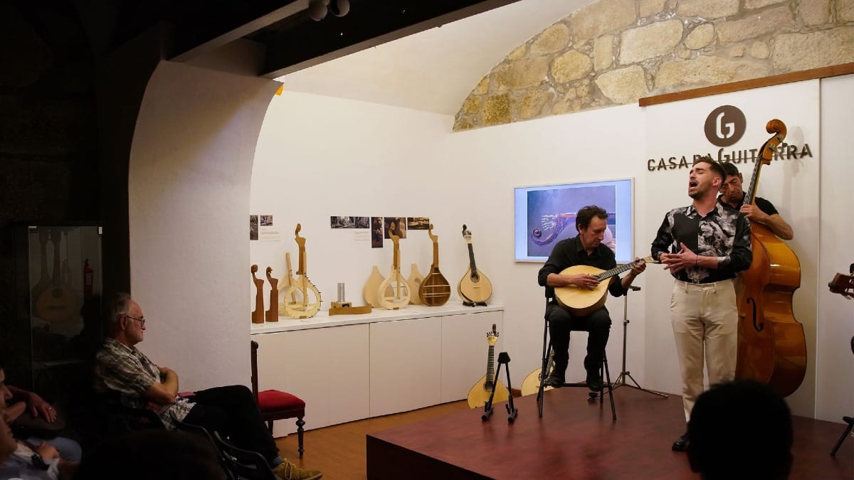 Male Fado singer performing on stage at Casa da Guitarra in Porto