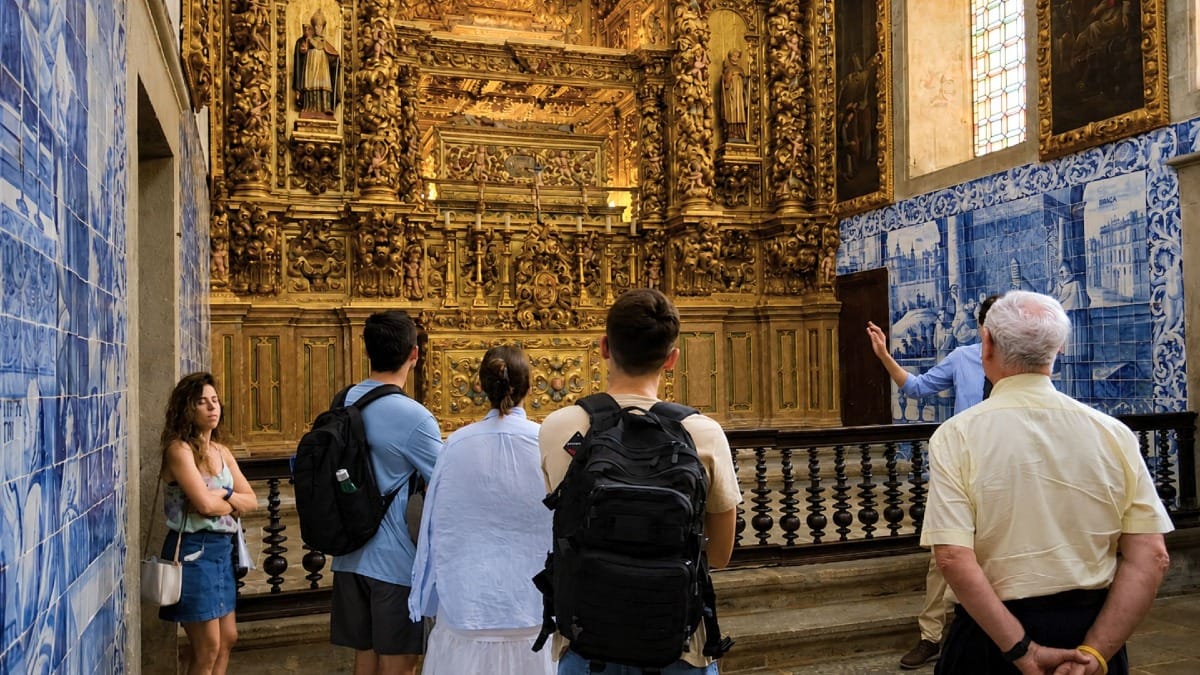 Visitors admiring Braga Cathedral's richly decorated chapels and historic azulejo tiles.