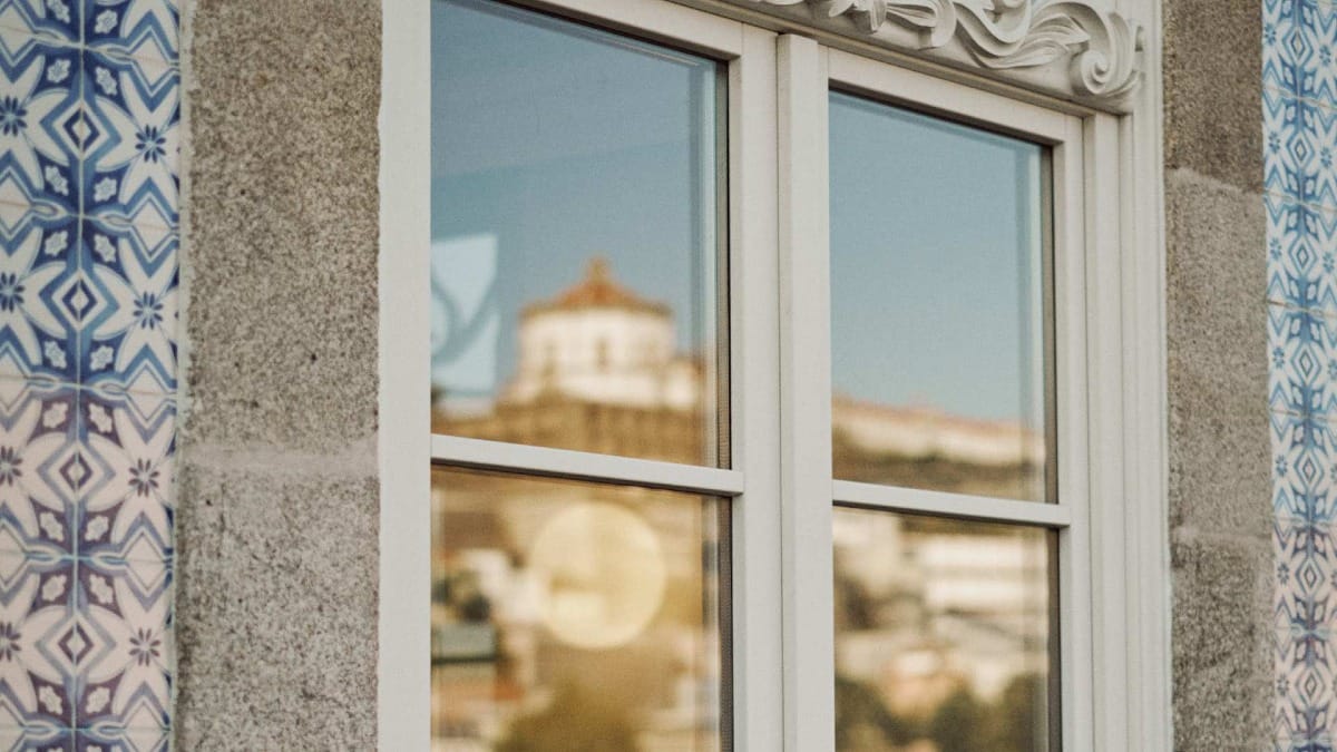 Reflection of Serra do Pilar Monastery in the tasting room window of Poente by Vallado