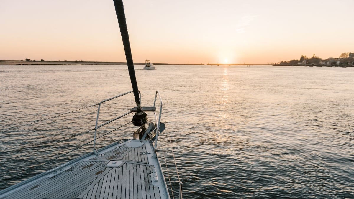 Scenic sunset boat tour in Porto with vibrant orange sky over the Atlantic Ocean horizon