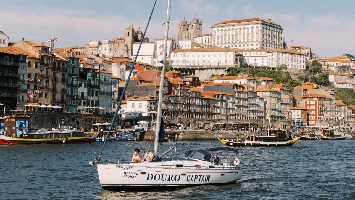 Private boat in Porto with guests passing by the UNESCO World Heritage site of Ribeira