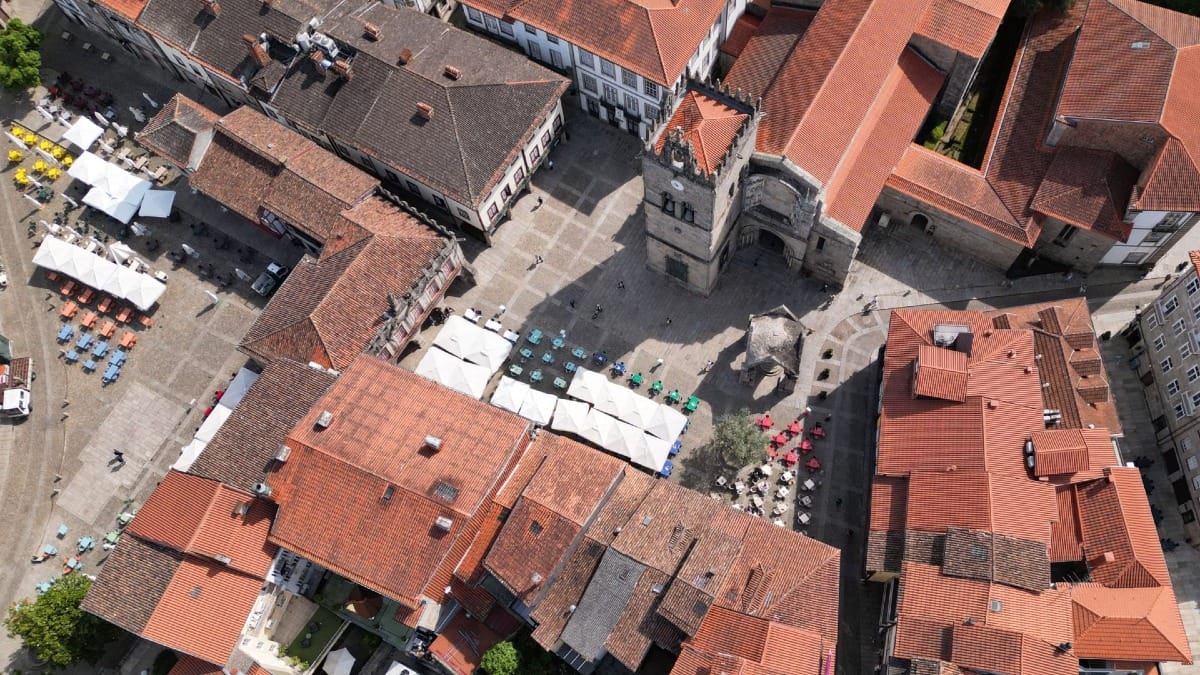 Vista aérea do Largo da Oliveira e das arcadas medievais em Guimarães durante um tour com a Cooltour Oporto