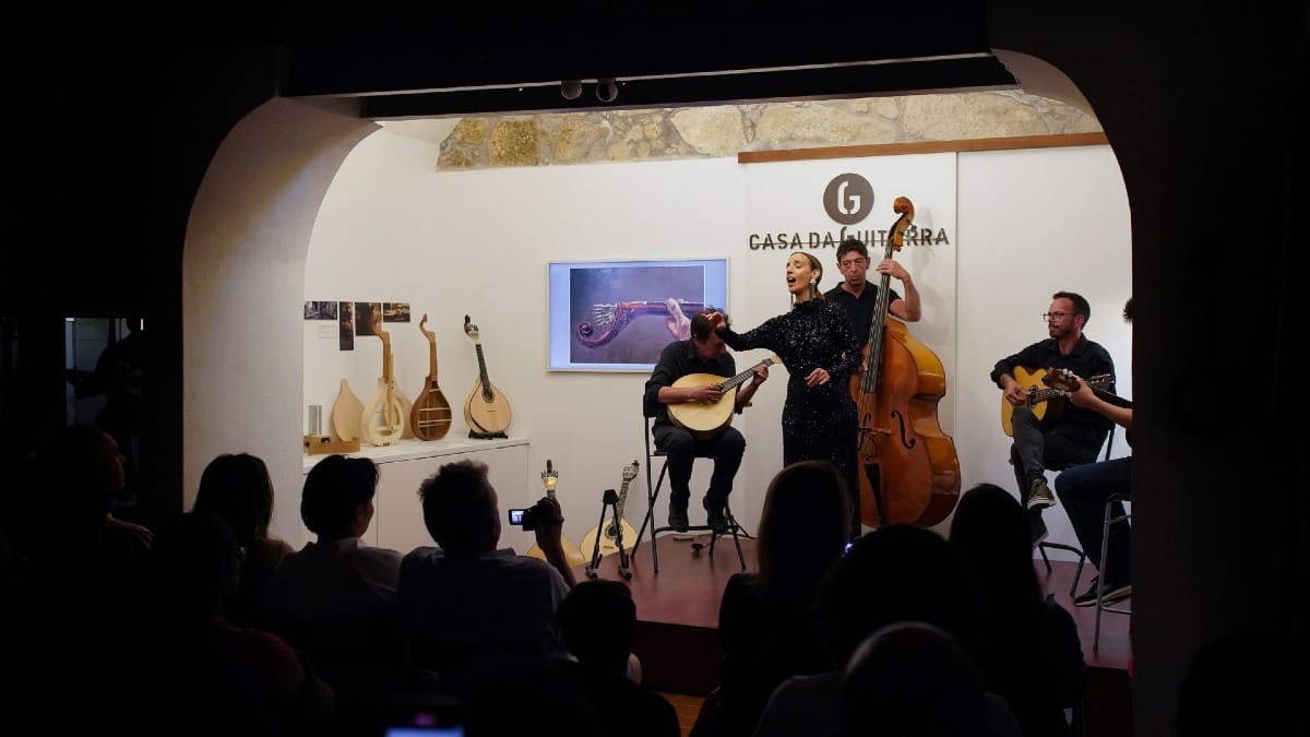 Female Fado singer engaging with the audience at Casa da Guitarra in Porto