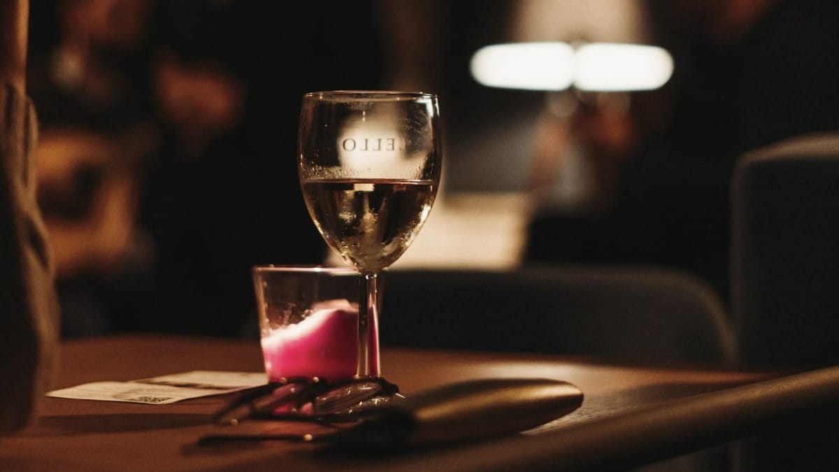 Romantic setting with a candlelit table and wine glass during a Fado show in Porto