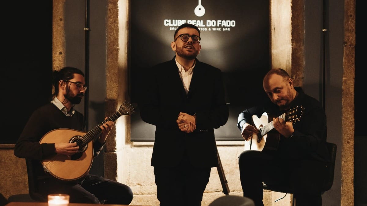Fado trio singing and playing live music in a wine bar located in Portoās historic district