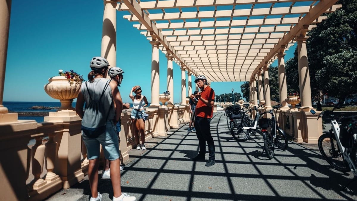 Small group on an electric bike tour along Porto’s riverbank and coastal area, stopping at the famous Pérgola da Foz with panoramic ocean views