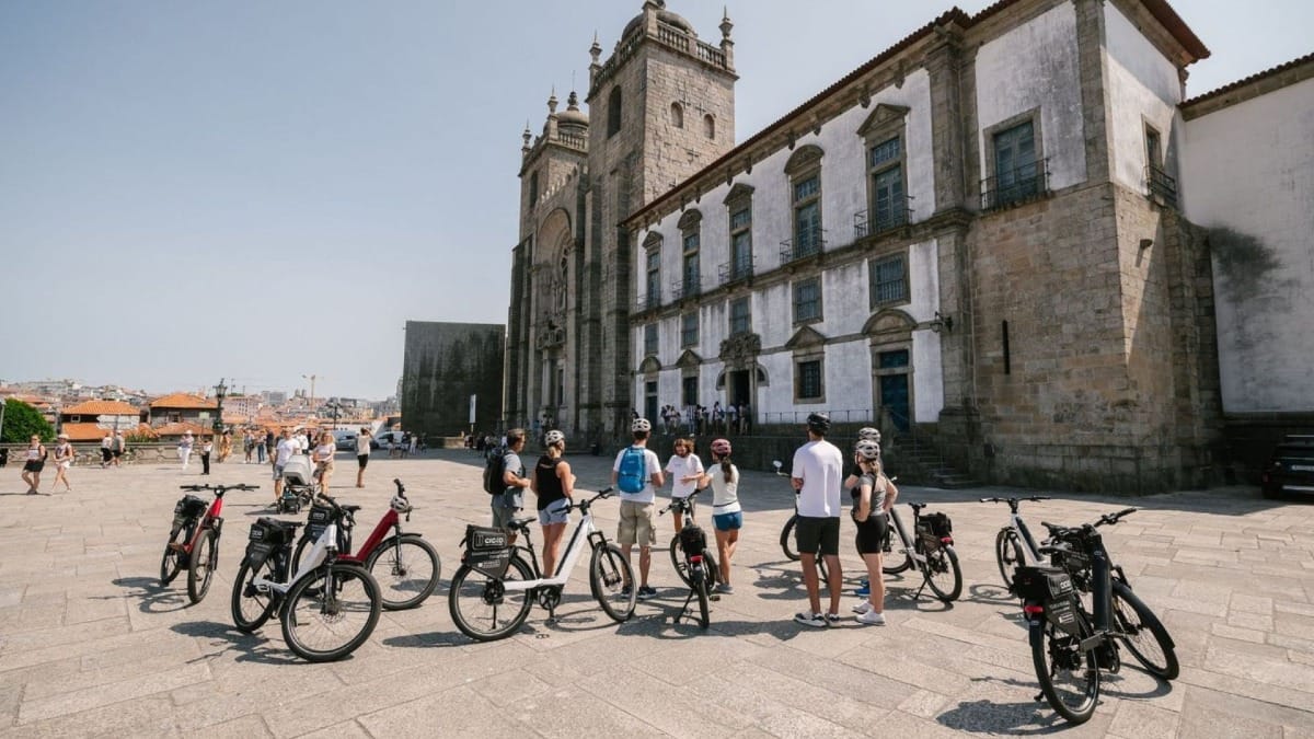 Groupe en visite à vélo électrique à Porto s'arrêtant devant l'emblématique Cathédrale de Porto