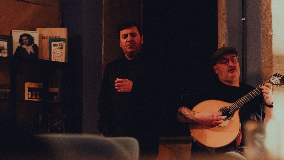 Fado musicians performing with emotion side by side in an intimate wine bar in Porto
