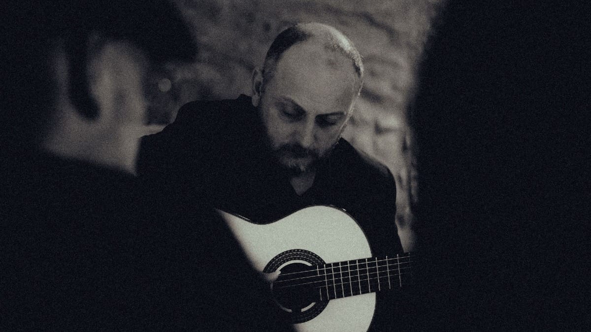Musicians playing Fado guitars with a close-up of the classical guitar being played