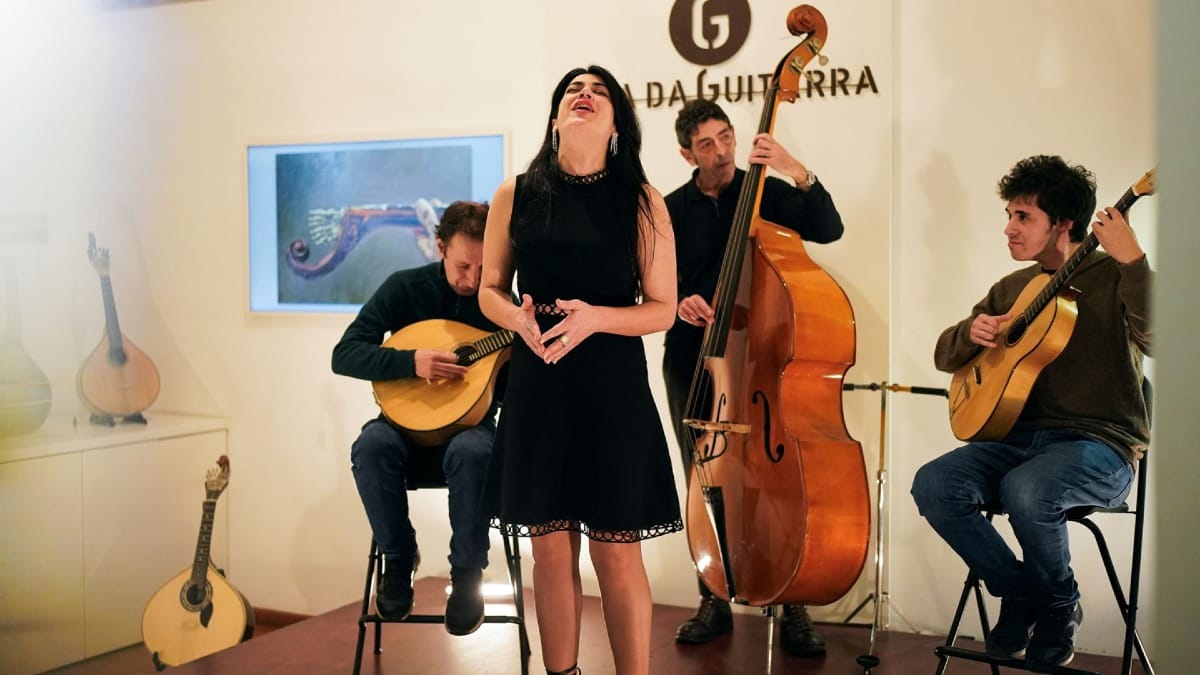 Live Fado concert at Casa da Guitarra in Porto with a female singer and musicians on stage