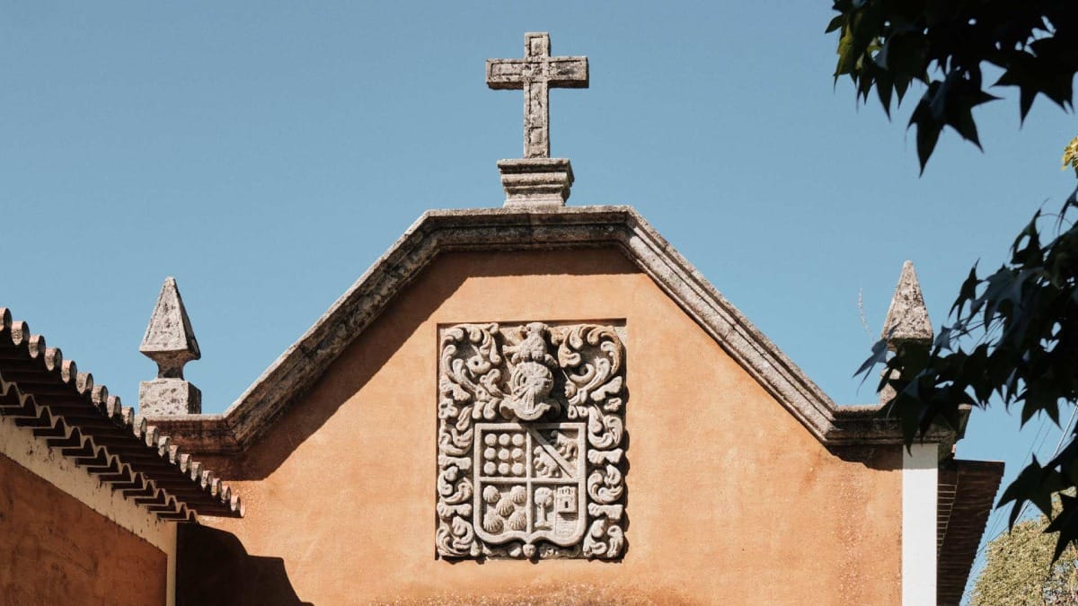 Historic crest and cross on the chapel facade of the Quinta do Vallado estate in the Douro Valley