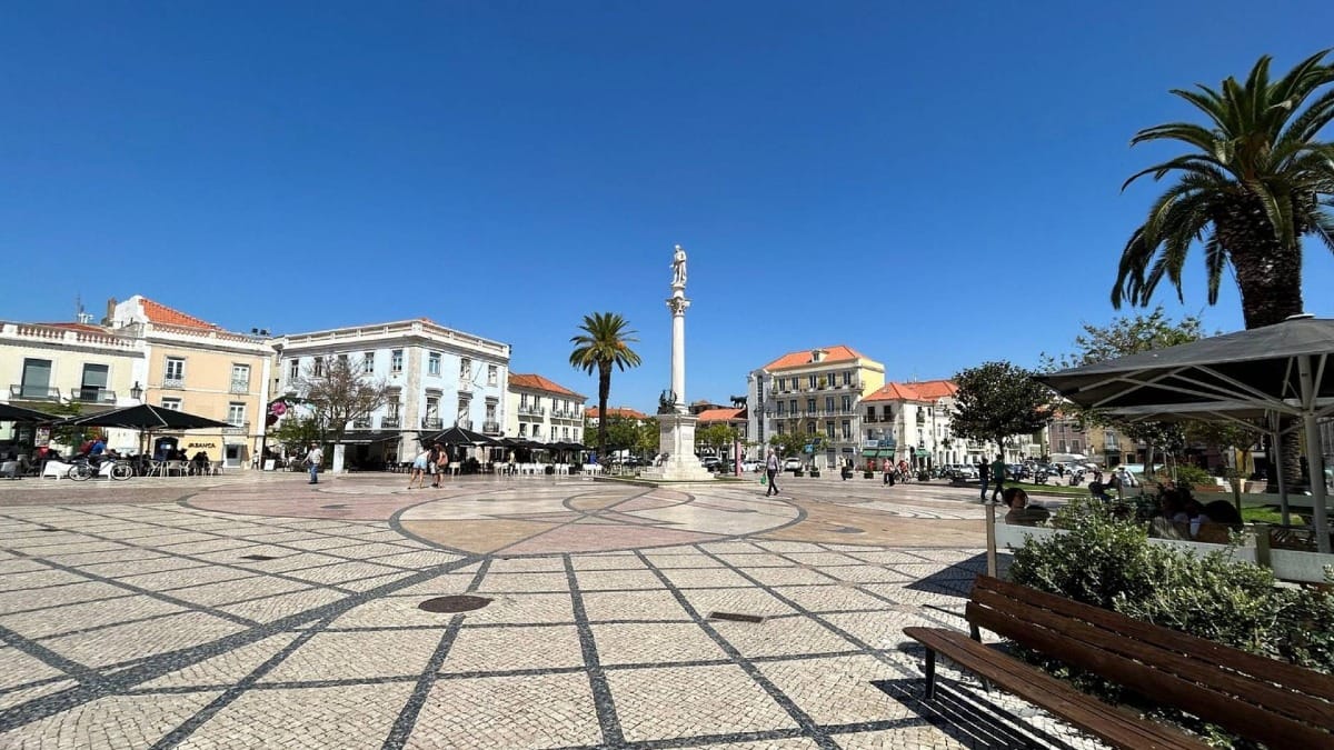 Praça do Bocage in Setúbal with tiled pavement, cafés, and the statue of poet Bocage in the center