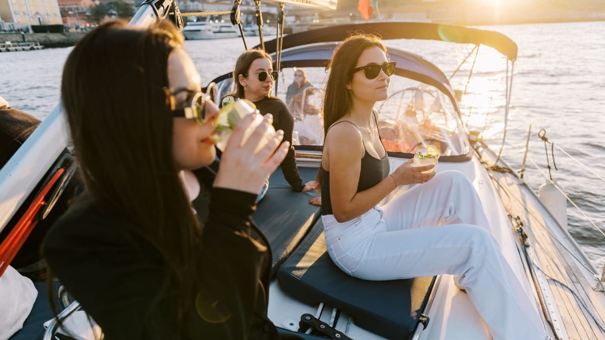 Guests enjoying a cocktail during a Douro River cruise in Porto with wine tasting