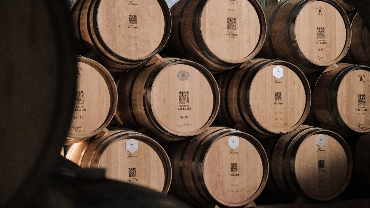 Wooden barrels stacked in a Douro Valley cellar at Quinta do Vallado winery