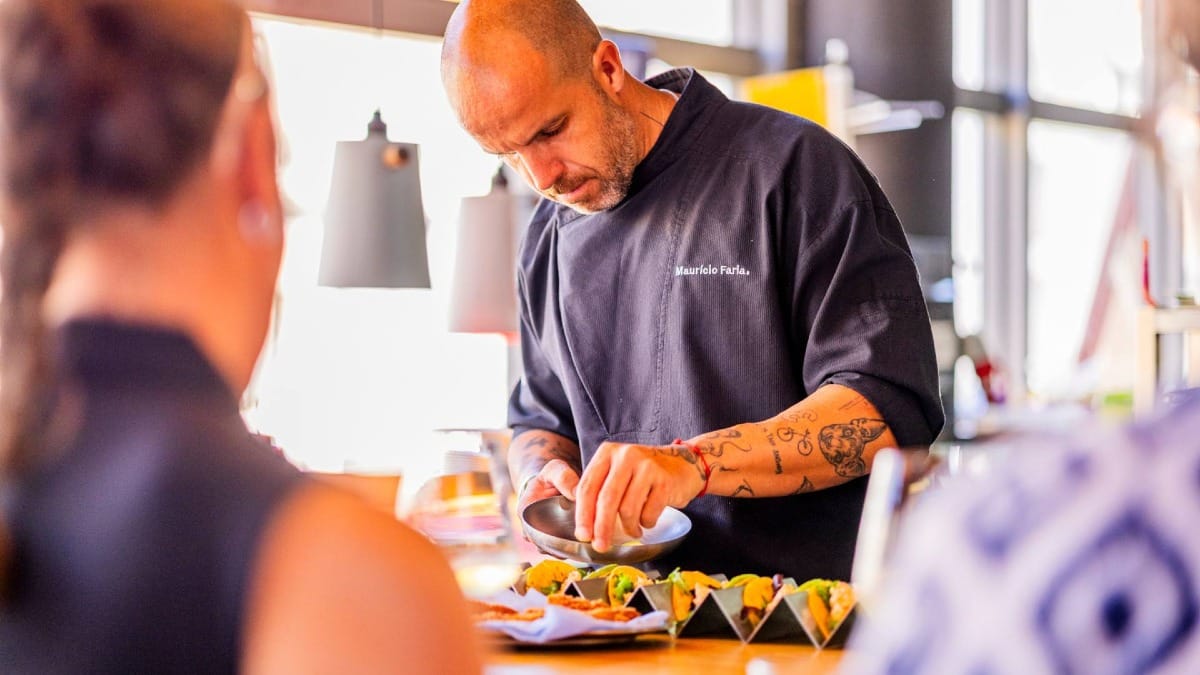 A personal moment as the chef serves freshly prepared dishes to guests