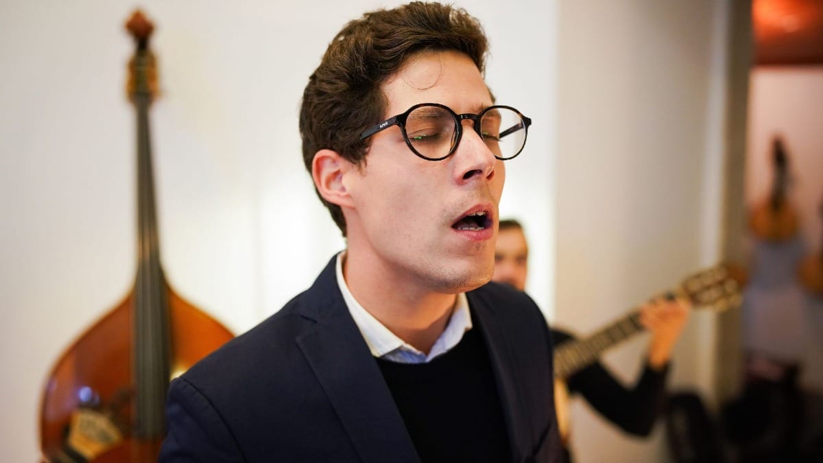 Male Fado singer with eyes closed, expressing emotion at Casa da Guitarra in Porto