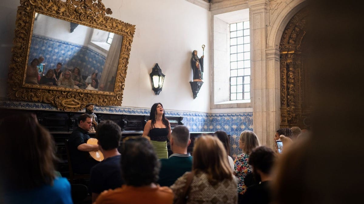Fado singer performing a traditional Fado concert in the historic São Bento Monastery in Porto, Portugal