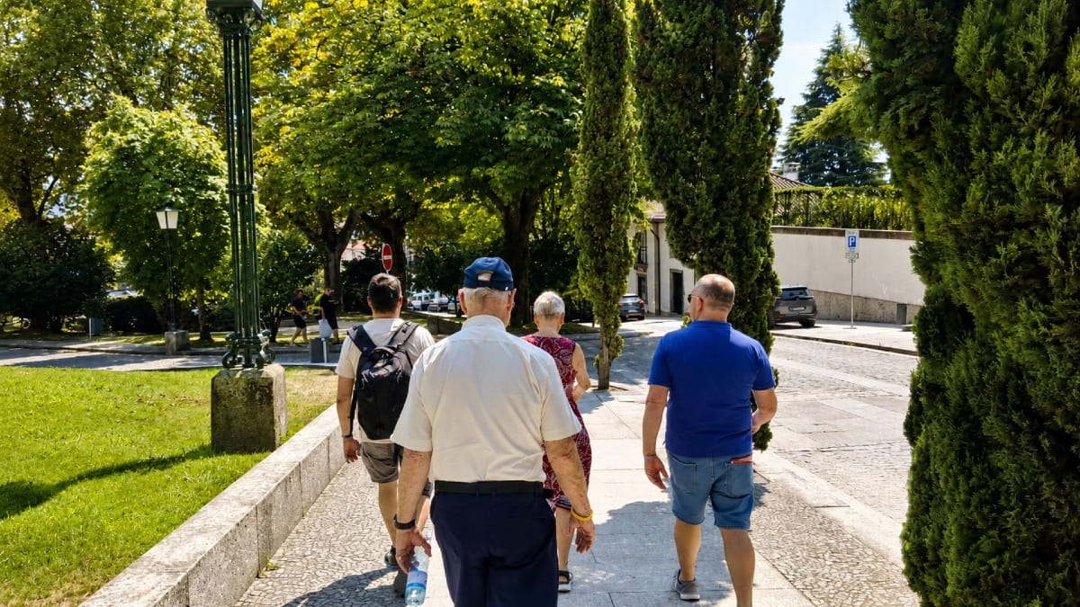 Guests walking down the Castle hill towards the historic centre of Guimarães with a local guide from Cooltour Oporto.