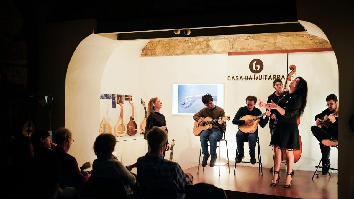 Traditional Fado music live at Casa da Guitarra with musicians on stage in Porto