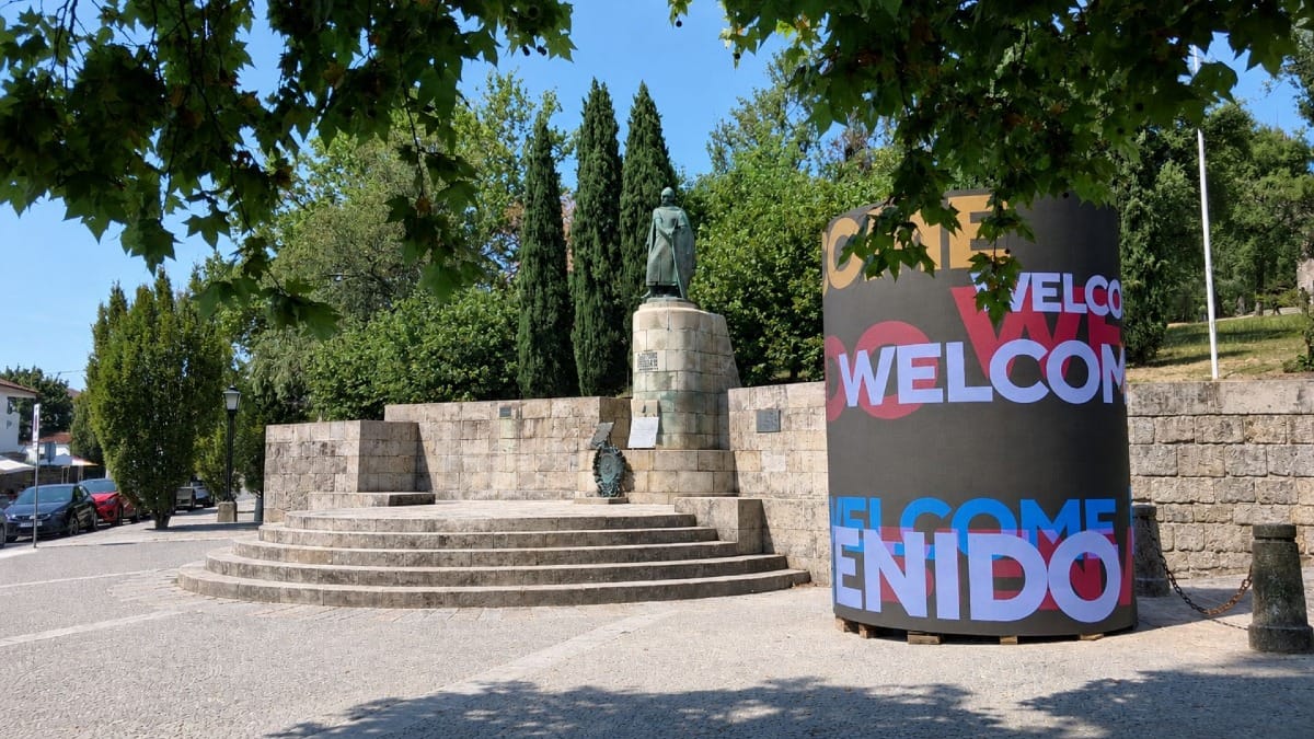 Visitors arriving in Guimarães at the city's iconic welcome sign during a private tour from Porto.