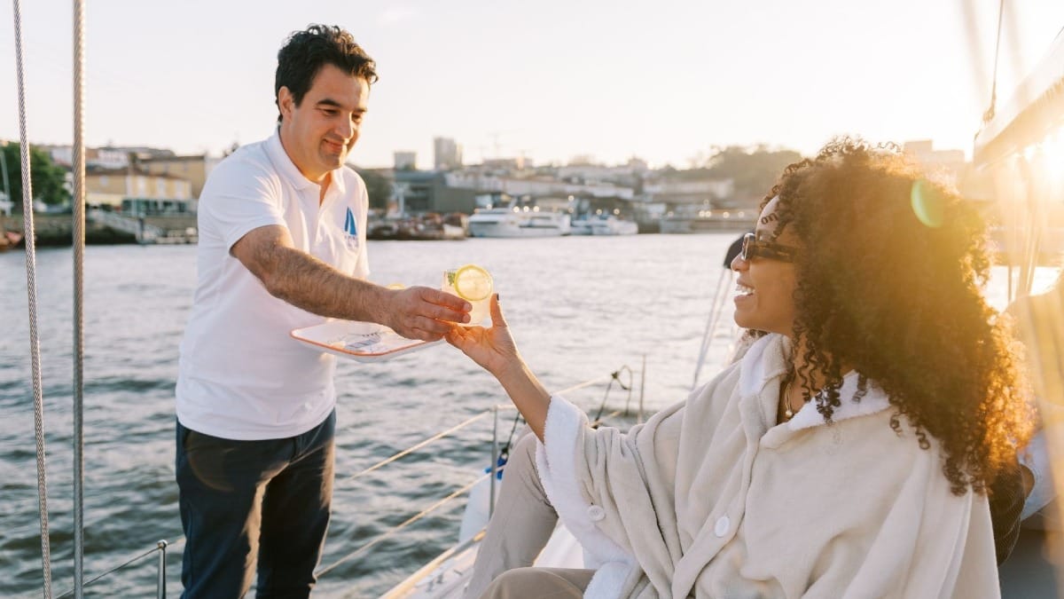 Skipper servant un cocktail lors d'une croisière privée exclusive au coucher du soleil sur le fleuve Douro