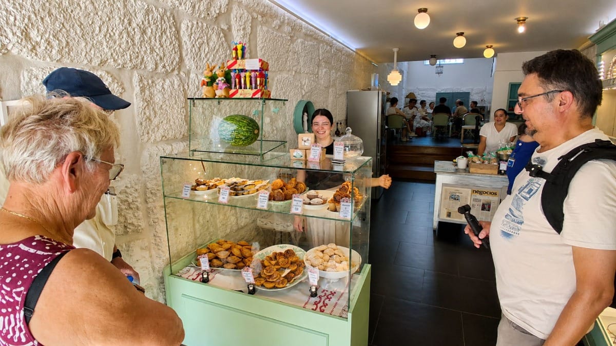 Guests enjoying a traditional Portuguese pastry during a relaxing stop in Guimarães' historic centre.