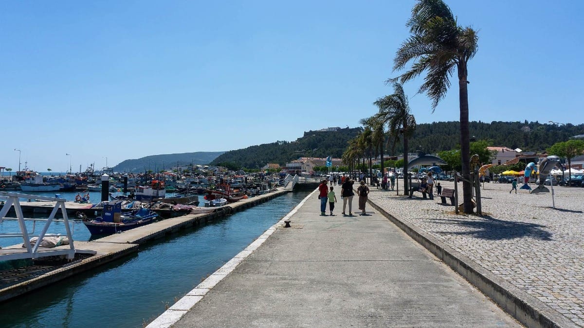 Avenida José Mourinho in Setúbal with boats docked at the marina and tiled rooftops in the foreground
