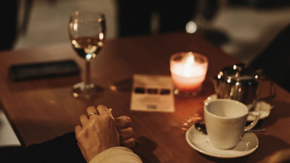 Romantic couple enjoying a live Fado show at a candlelit table in a cozy wine bar in Porto