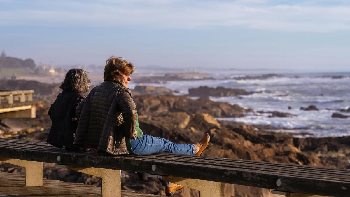 Couple enjoying the ocean and rocky coastline of Matosinhos near Porto on an electric bike tour