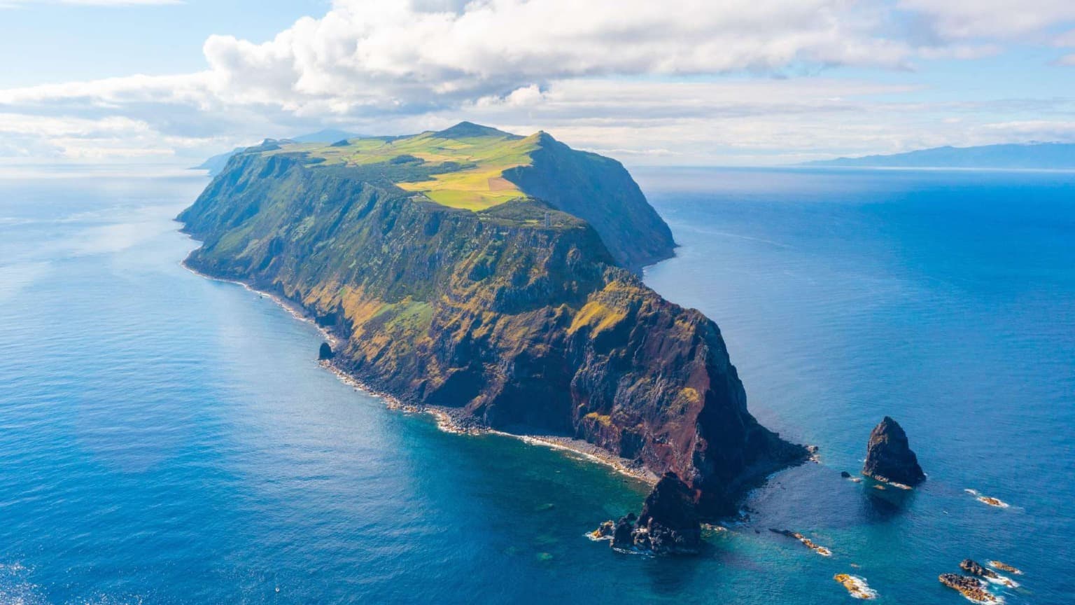 Aerial view of the cliffs and green plateau of São Jorge Island in the Azores