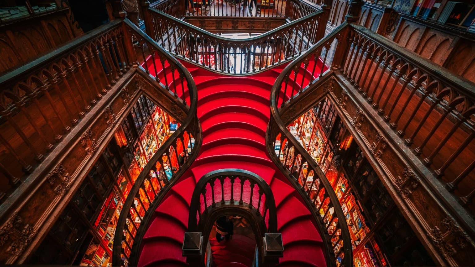 The iconic crimson staircase inside Livraria Lello in Porto, Portugal