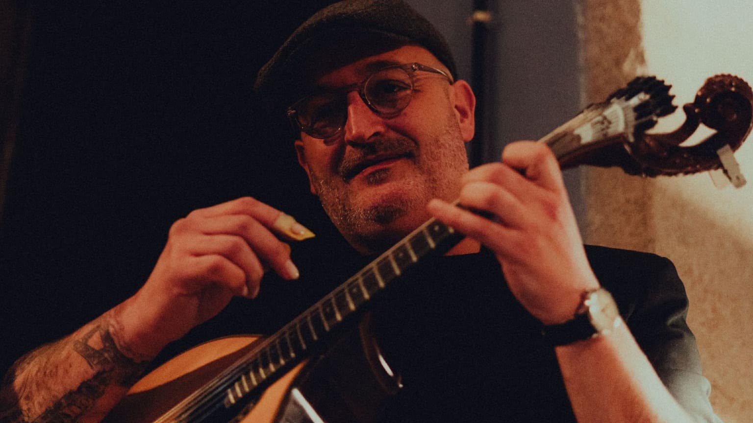 Portuguese guitar musician performing traditional Fado music in Portugal