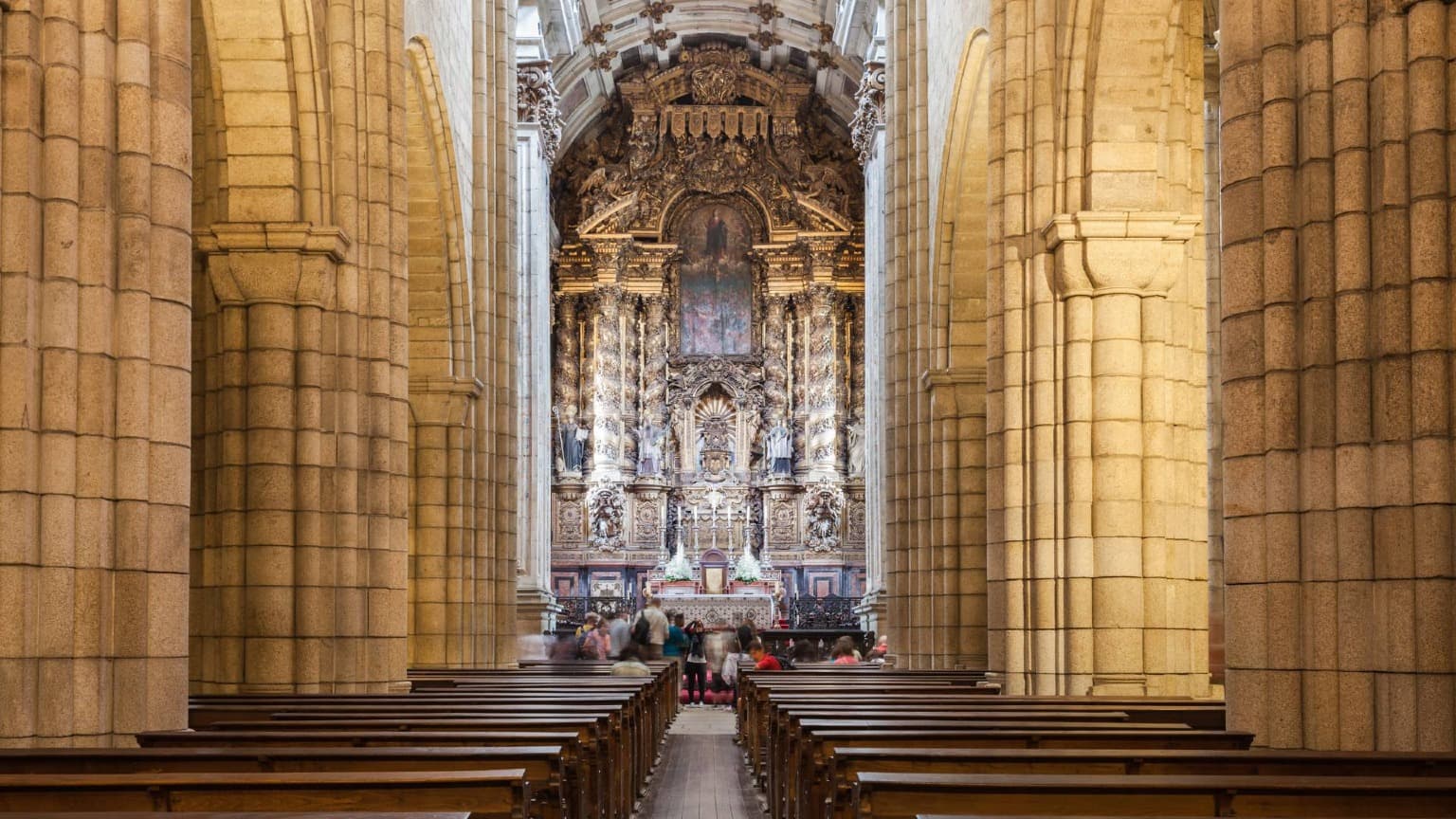 Interior nave of Porto Cathedral with its Romanesque architecture and Baroque main altar