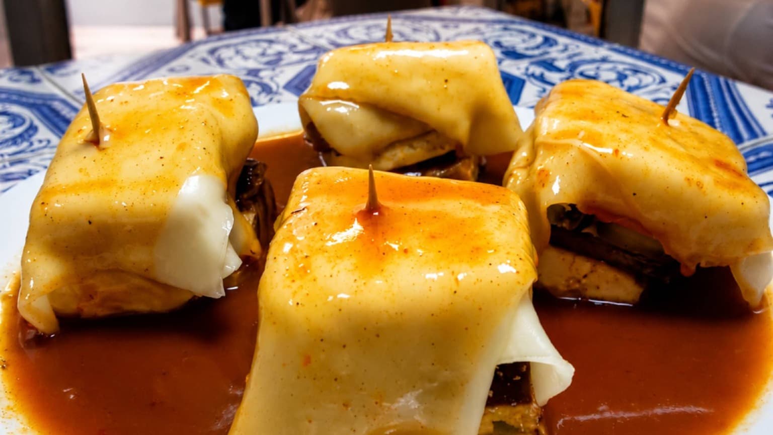 Vegan Francesinha served at Lupin Snack Bar in Porto with plant-based ingredients and traditional-style sauce
