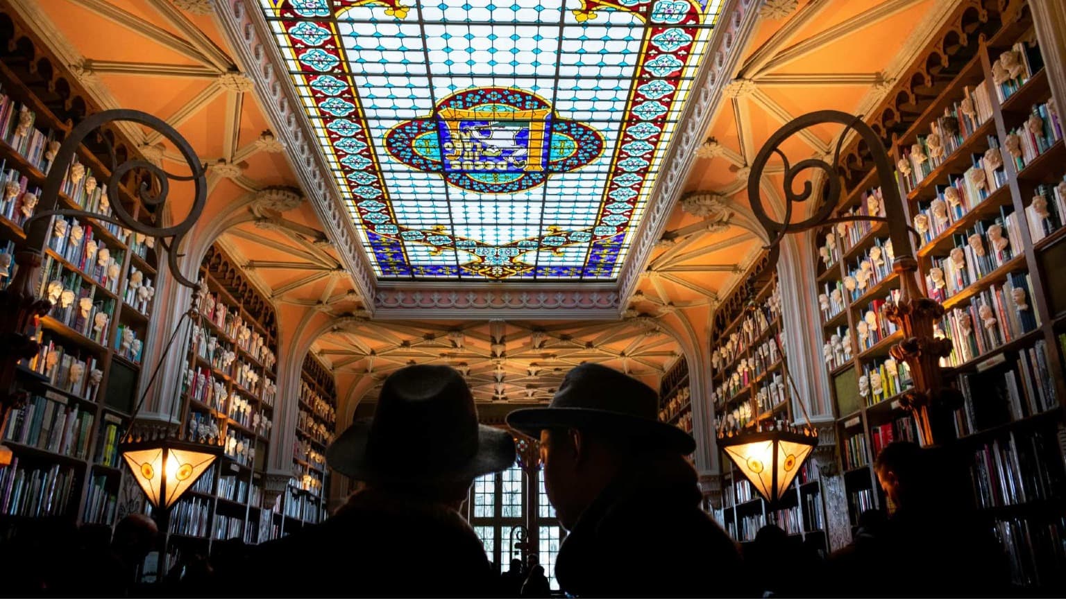 Interior of Livraria Lello in Porto with its iconic staircase and stained glass ceiling