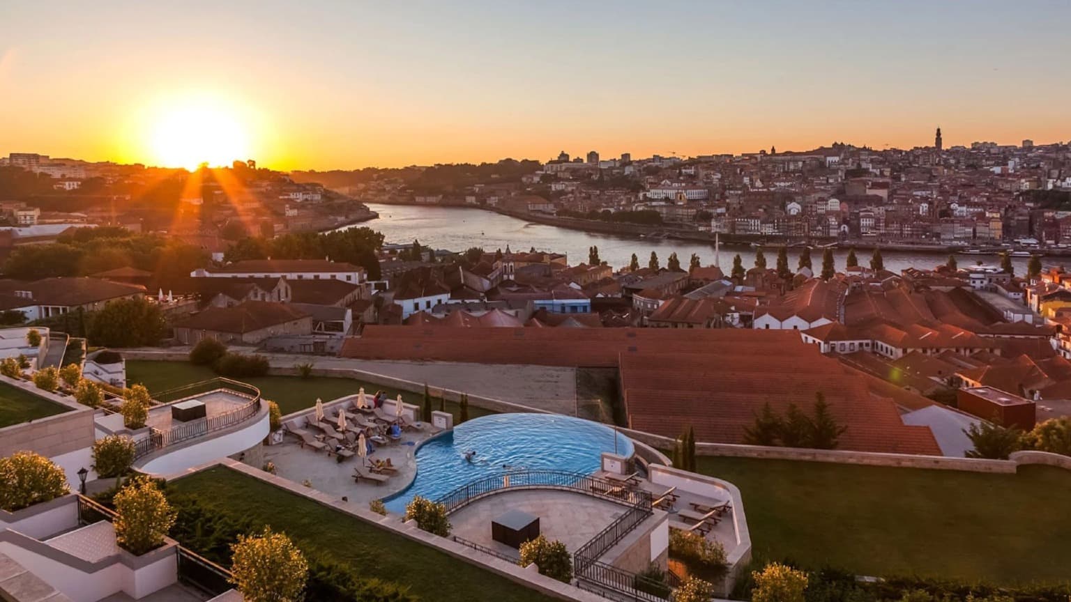 Vista panorámica de la puesta de sol sobre Oporto y el río Duero desde la terraza y la piscina infinita del hotel The Yeatman en Vila Nova de Gaia.
