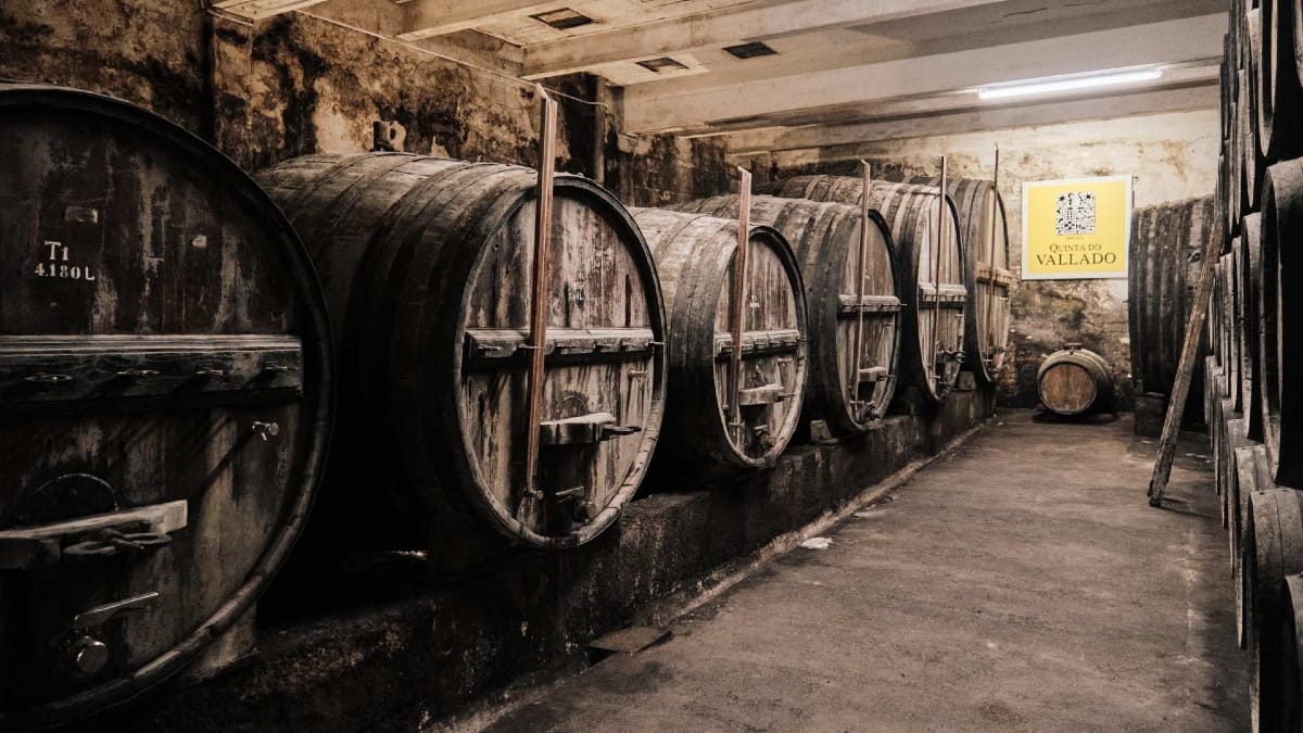 Aged wooden barrels in the historic wine cellar at Quinta do Vallado, used for maturing Port wine