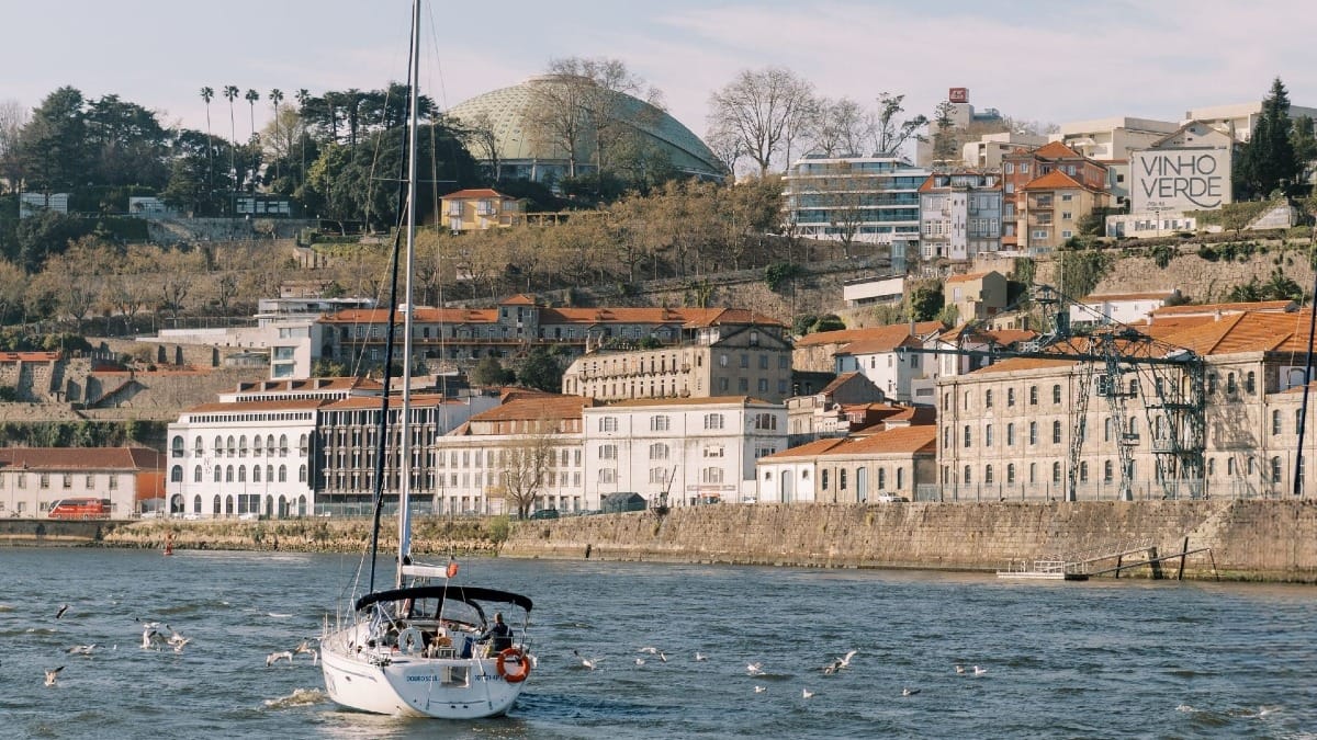 Private sailing boat on the Douro River in Porto heading towards the Atlantic Ocean