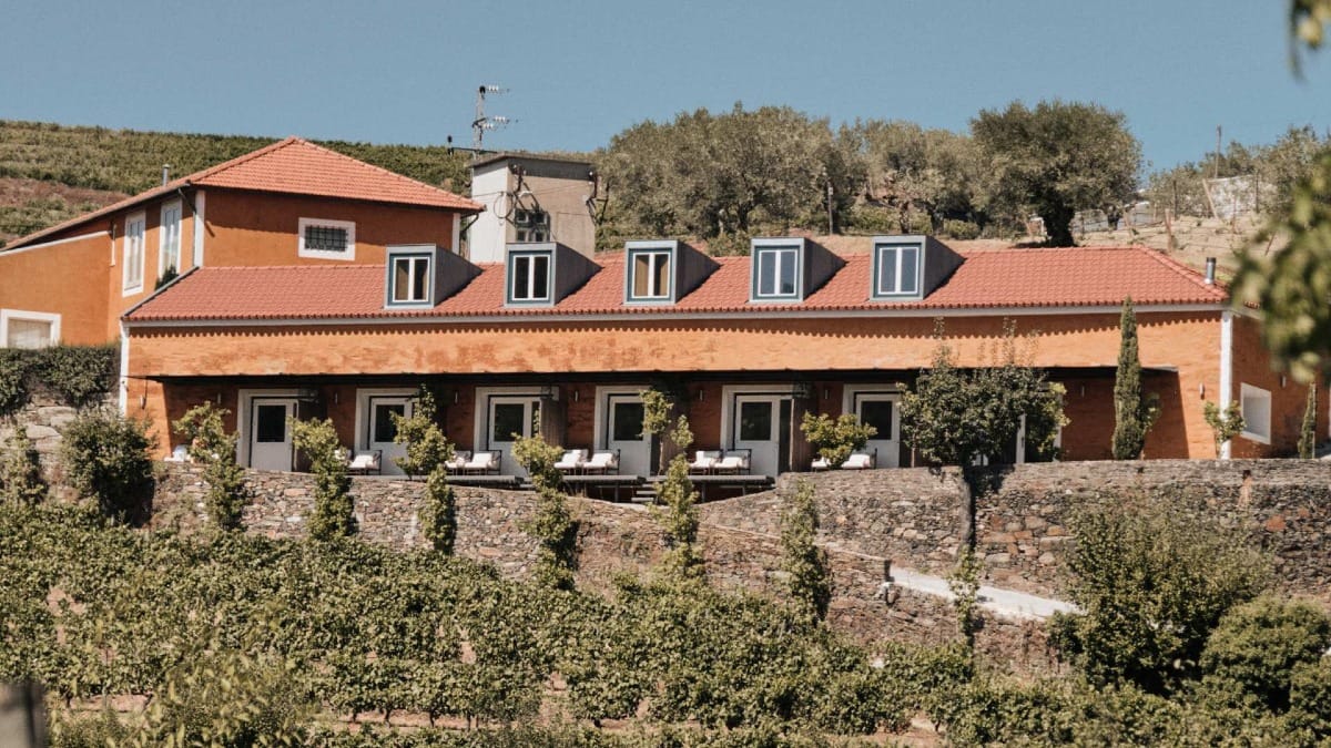 Main building of Quinta do Vallado surrounded by vineyard terraces in the Douro Valley