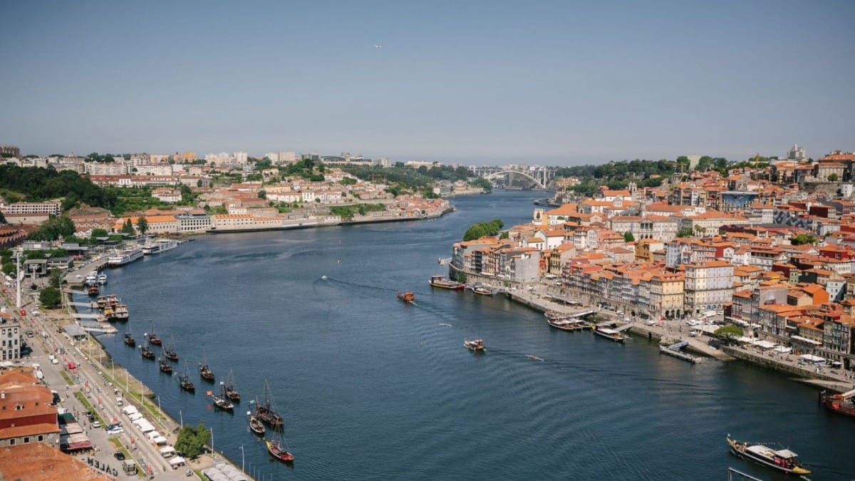 Stunning view from Serra do Pilar viewpoint with the blue Douro River, Port wine cellars, and Arrábida Bridge