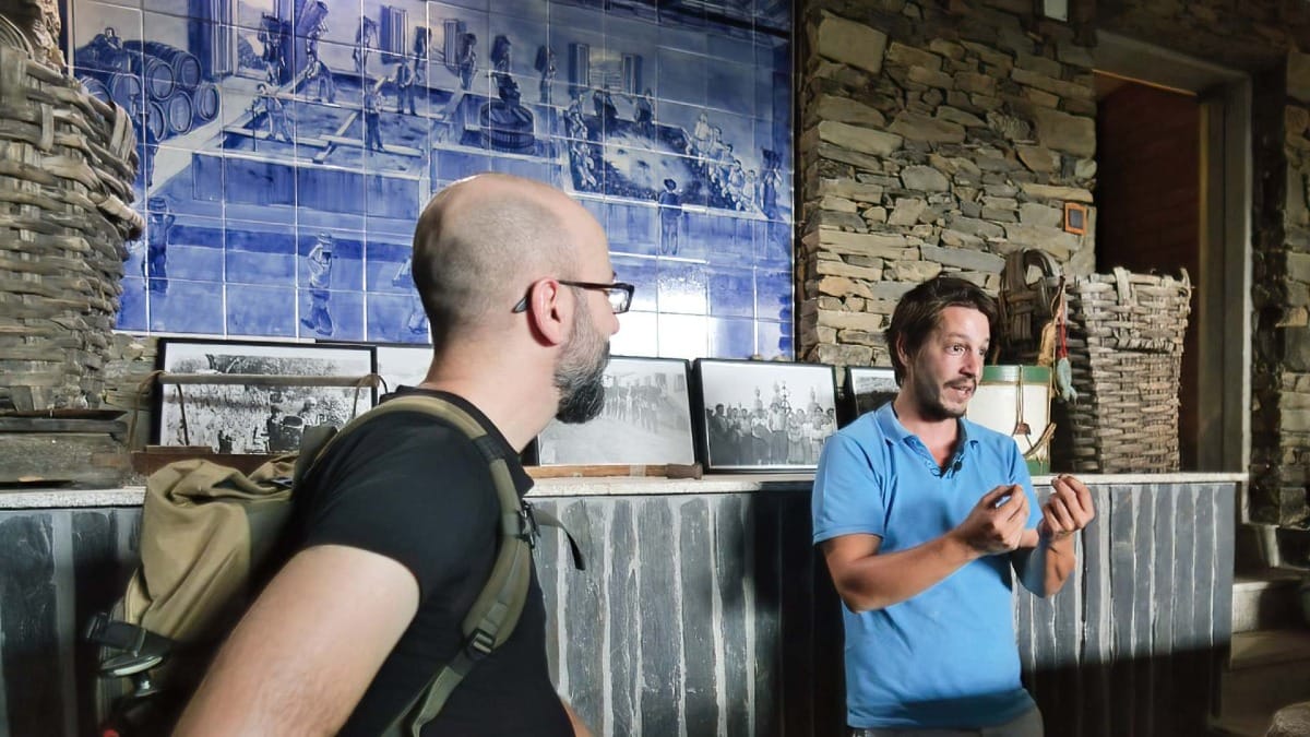 Inside the historic lagares room with tile mural and wine heritage