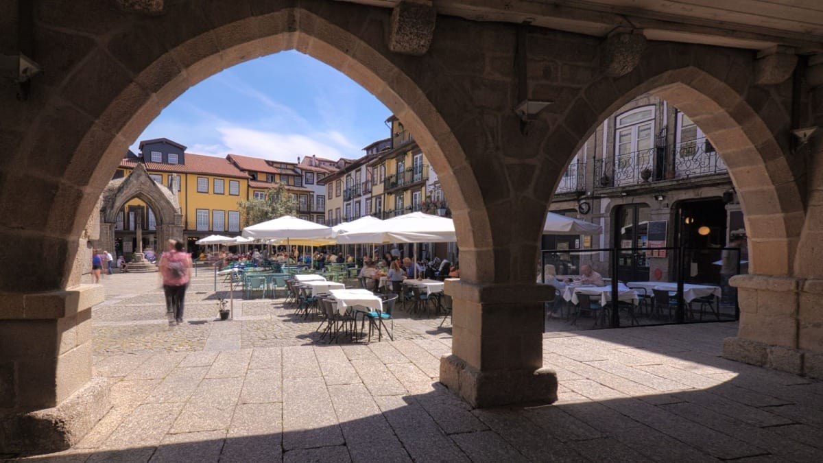 Historic arcades at Largo da Oliveira in Guimarães, UNESCO World Heritage Site, during a guided tour from Porto with Cooltour Oporto