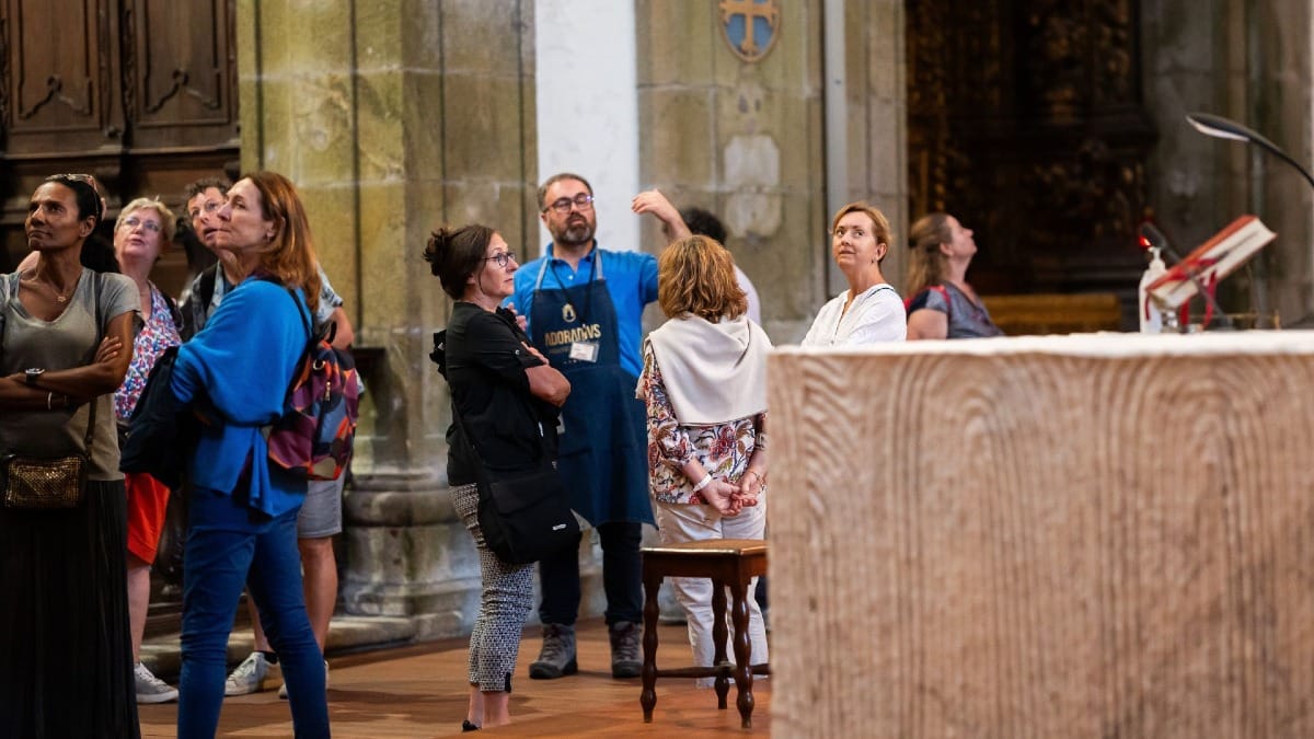 Monk explaining the heritage and history of the Monastery to an audience in Porto, Portugal