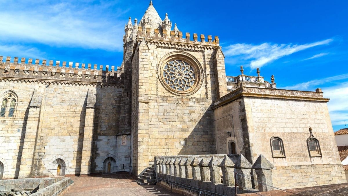A unique upper-level perspective of Évora Cathedral revealing its stunning Gothic rosette and the rich architectural layers of the old city.